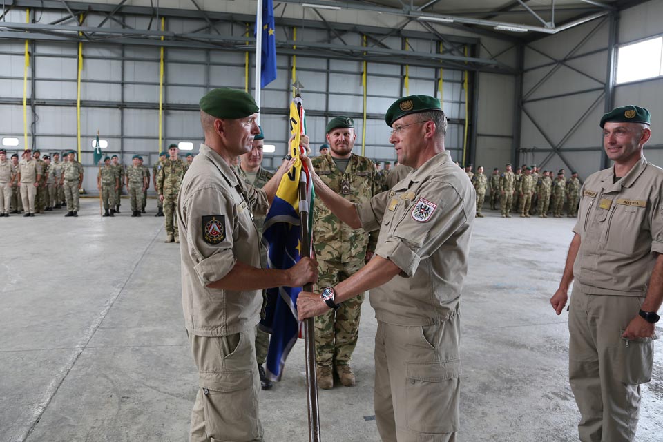 COMEUFOR hands the MNBN Colours to Lieutenant Colonel Oliver Pilles