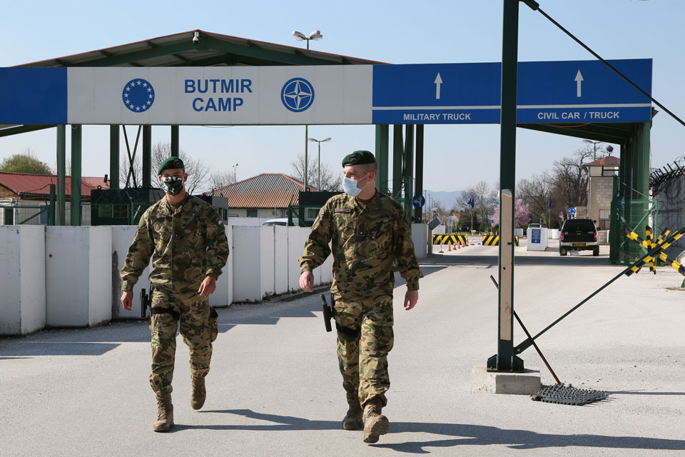 Guards in masks at the entrance to Camp Butmir