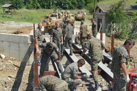 Military engineers work together on bridge building task